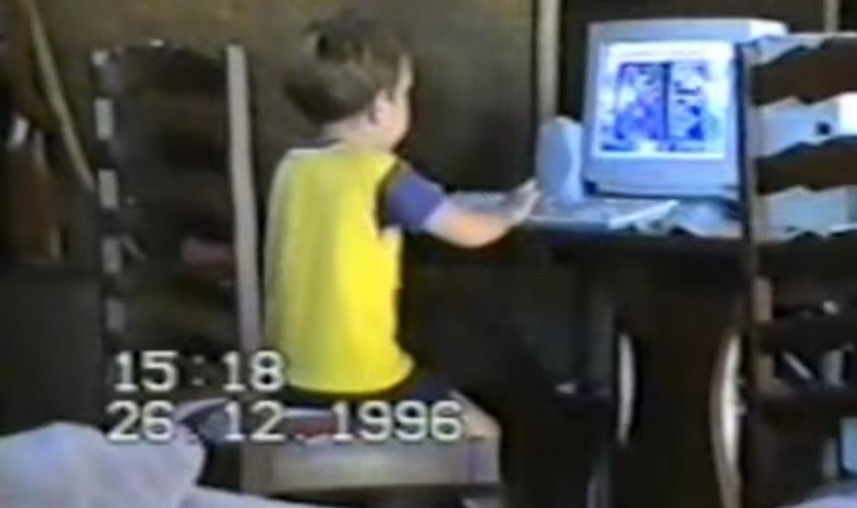 A picture of the author when he was 6 sitting in front of a CRT monitor playing space cadet pinball